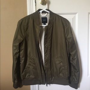 Army green bomber with zipper on sleeve.